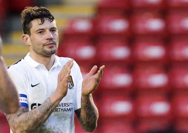 Marc Richards applauds the Cobblers supporters following the Walsall defeat