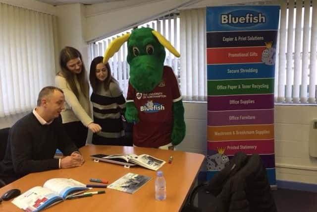 Clarence the dragon visiting the offices of Bluefish Office Supplies