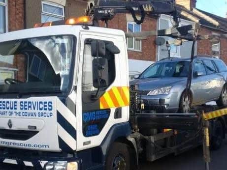 A vehicle is removed from Hunter Street