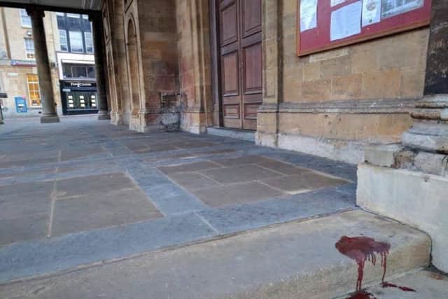 A pool of blood on the steps of All Saints Church on Sunday