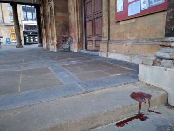 A pool of blood on the steps of All Saints Church on Sunday