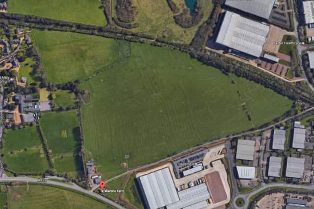 The green buffer zone between Great Houghton (left) and the Brackmills Industrial Estate, right, will have two warehouses built on it.