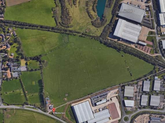 The green buffer zone between Great Houghton (left) and the Brackmills Industrial Estate, right, will have two warehouses built on it.