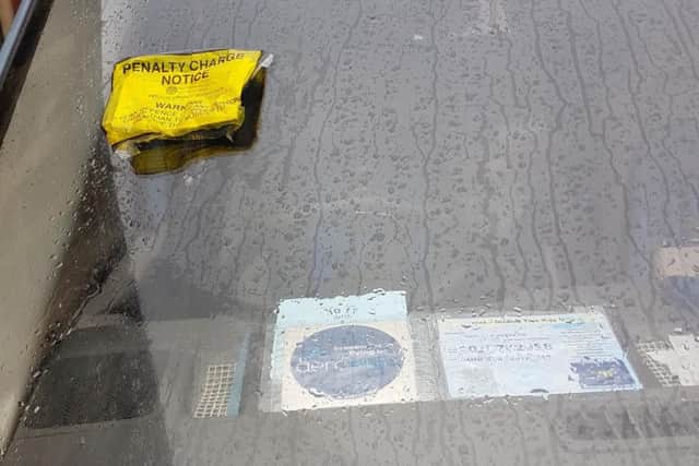 Carl and Gillian's parking fine next to their displayed blue badge.