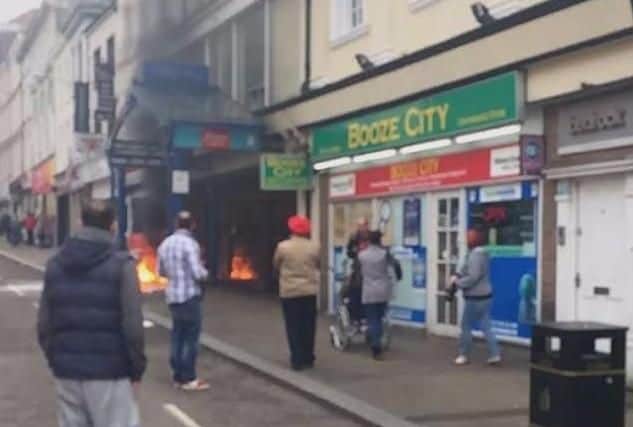 Onlookers stare at the flames