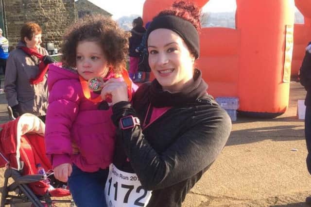 Amy and her daughter Hettie at the finish line of one of her training races.