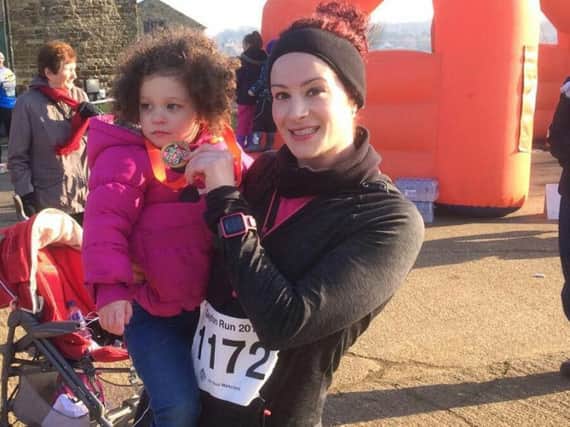 Amy and her daughter Hettie at the finish line of one of her training races.