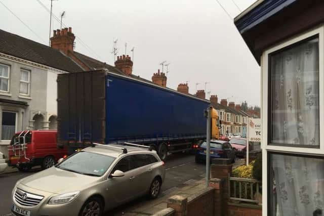 A lorry blocks up Glasgow Street with cars lined either side.