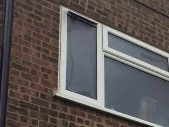 A man was seen dangling from the window as 'thick black smoke' came from the vents.