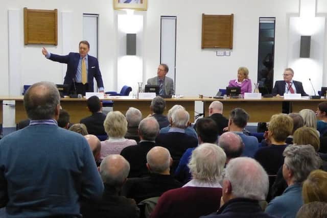 Transport minister John Hayes addresses the public meeting