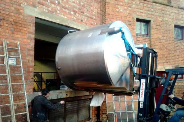 To fit the tank into their headquarters, Phipps had to remove a window.