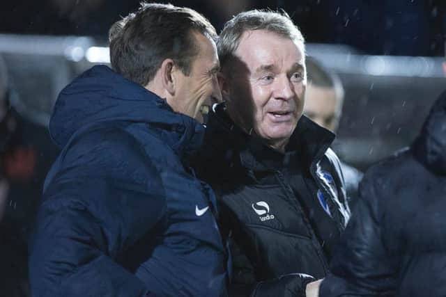 Cobblers boss Justin Edinburgh shares a joke with Oldham manager John Sheridan before kick-off