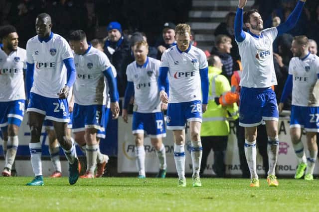 Oldham's players celebrate their late winner