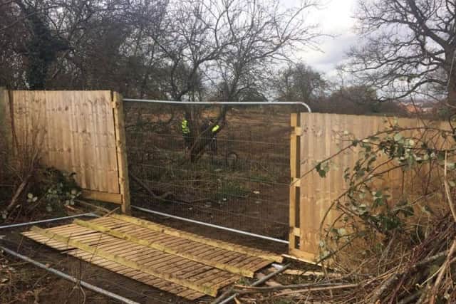 A fence panel was pulled down to access the site.