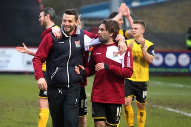 Ricky Holmes celebrates the dramatic win at Stevenage last season with Cobblers skipper Marc Richards