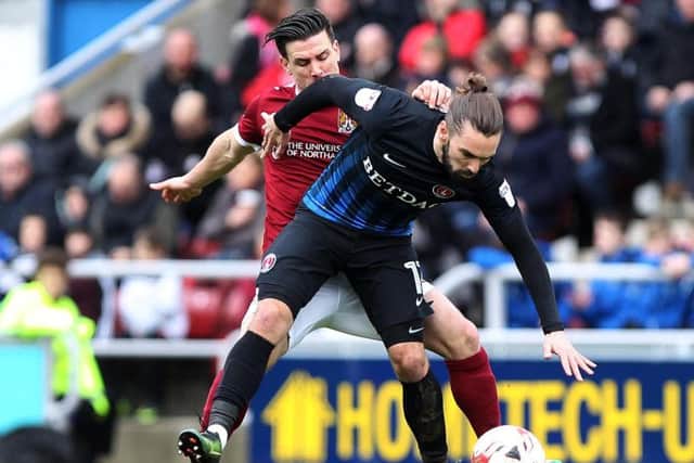 NOWHERE TO GO - Dave Buchanan stayed close to Ricky Holmes in the Cobblers' 2-1 win over Charlton (Picture: Sharon Lucey)