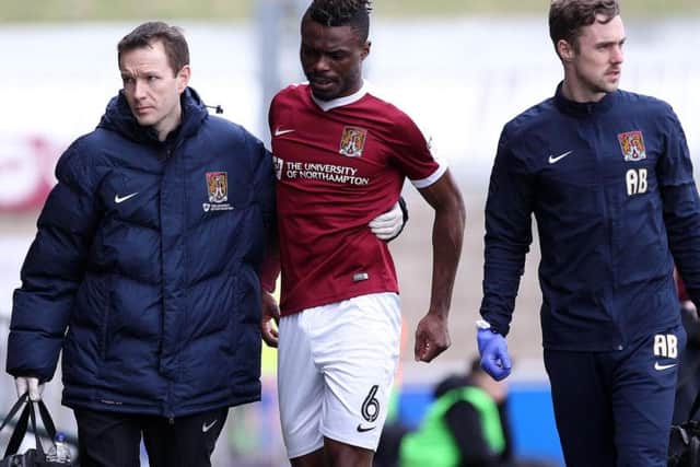 Gaby Zakuani is helped off the pitch after damaging his hamstring in Saturday's 2-1 win over Charlton Athletic (Picture: Sharon Lucey)