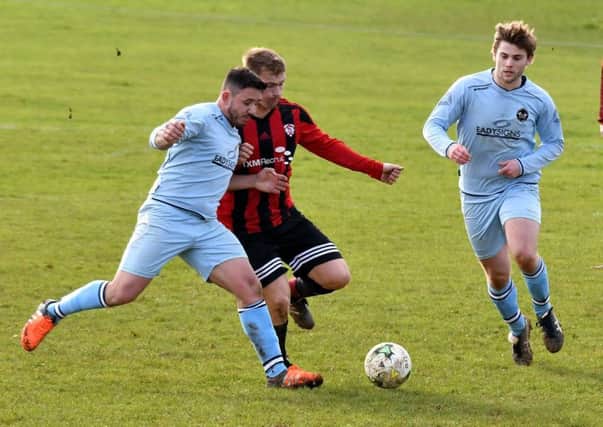 Action from premier division leaders Kettering Nomads' 1-0 win at Brixworth All Saints (Pictures: Dave Ikin)