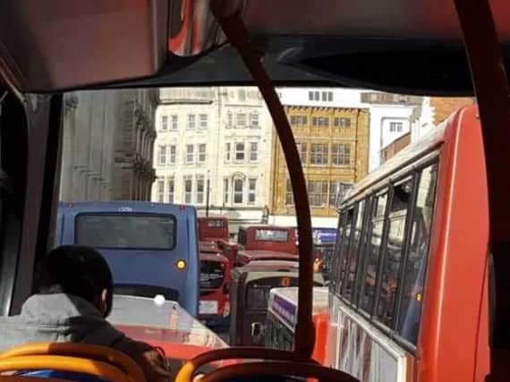 A bus passenger sits in Monday's traffic jam in The Drapery outside the North Gate Bus Station. Photo by Julian Marino.