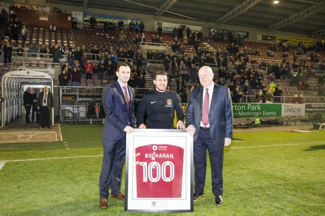 100-UP - Dave Buchanan is presented with a special framed Cobblers shirt ahead of Tuesday's win over Port Vale (Picture: Kirsty Edmonds)