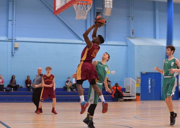 LEAPING HIGHEST - Chris Amankonah nets for Thunder Under-16s in their clash with Rutland Thunders (Pictures: Dave Ikin)
