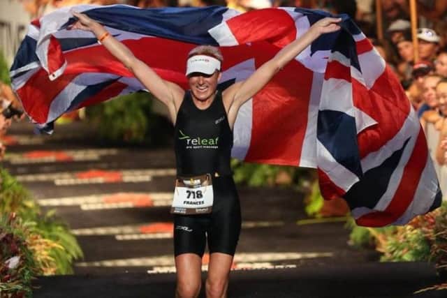 Frances crosses the finish line at the Ironman triathlon. This year's marathon will be her 16th.