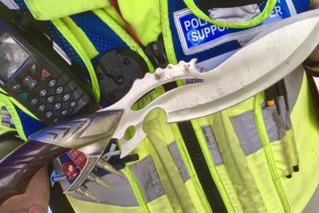 A police officer holding a blade