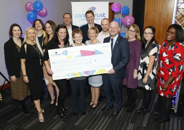 Rank Group Plc staff celebrate the Â£1.5m raised for the Carers Trust