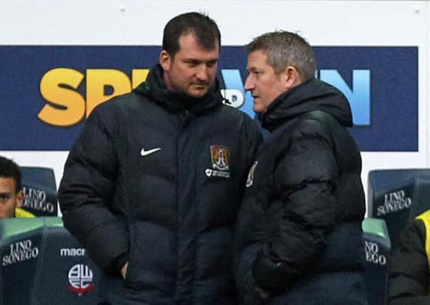 Cobblers assistant boss Dave Kerslake (right) chats to goalkeeping coach Jim Hollman during last weekend's defeat at Bolton