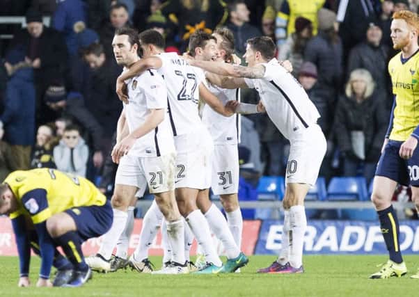 HAPPY MEMORY - Marc Richards is mobbed after his late, late winner at Oxford United on Boxing Day