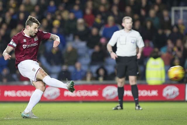 PICK THAT ONE OUT - Marc Richards hammers home the winning goal in the Cobblers' 1-0 win at Oxford last season