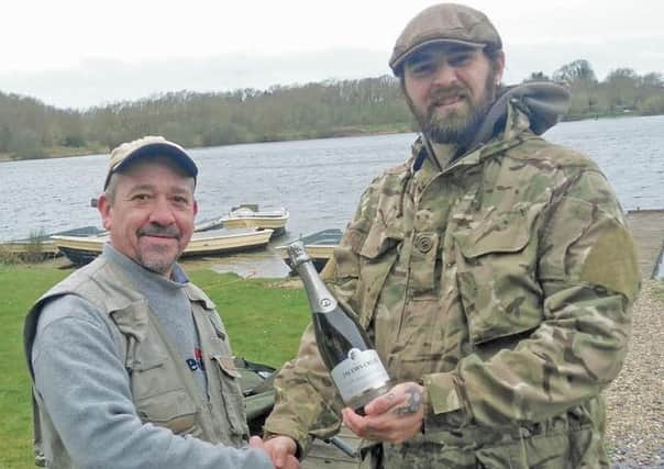 RINGSTEAD'S opening day brought Sean Roe (left) some good trout and a bottle of bubbly from bailiff Pete Booth