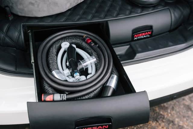 A blow dryer for wet fur is stored in a compartment in the boot.
