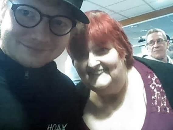 Pop star Ed Sheeran took a snap with a fan yesterday after supporting his hockey-player girlfriend, Cherry