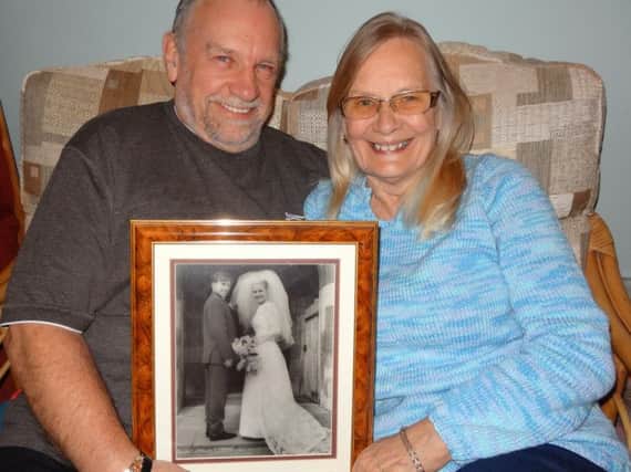 Keith "Chuck" and Jenny Luck, married for 50 years. Pictured here with their wedding photo.
