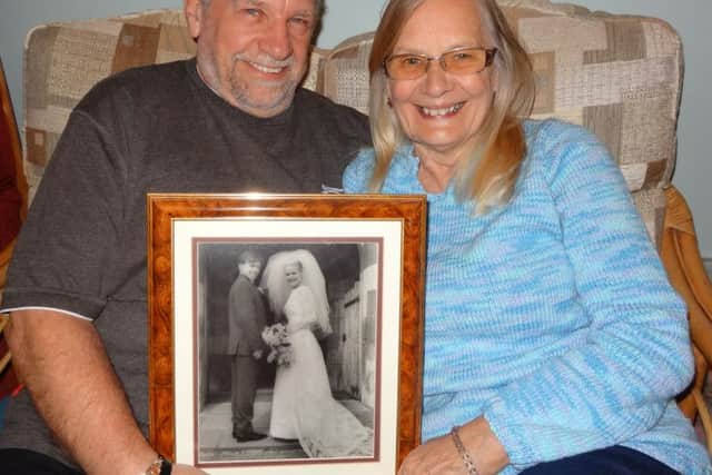 Keith "Chuck" and Jenny Luck, married for 50 years. Pictured here with their wedding photo.