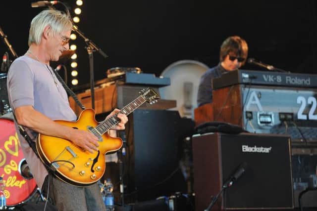 Andy Crofts on stage with Paul Weller at Delapre in 2013