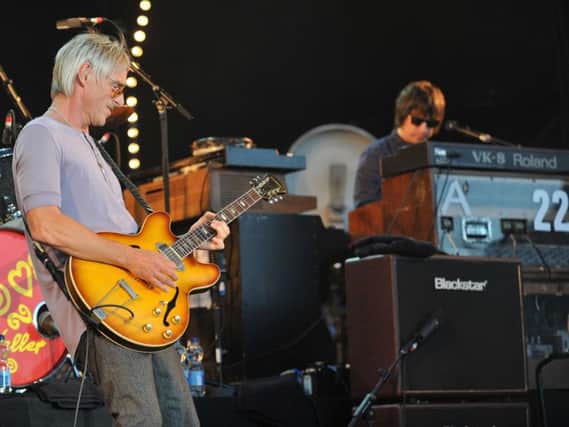 Andy Crofts on stage with Paul Weller at Delapre in 2013