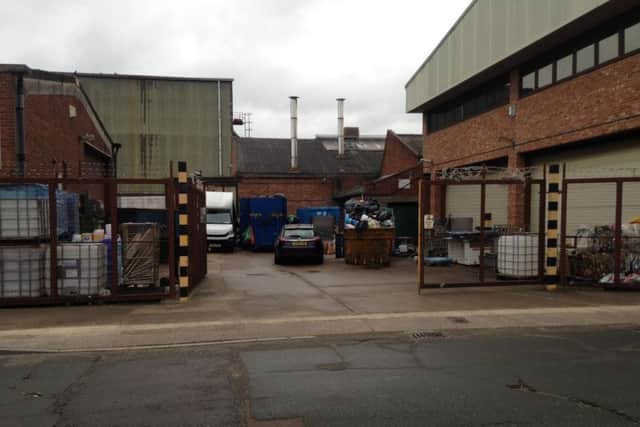 Picture shows waste piling out of a skip at the back of the Oliver Adams bakery.