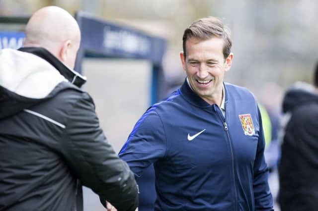 ALL SMILES: Justin Edinburgh was smiling both before and after Saturday's draw at Rochdale. Picture by Kirsty Edmonds