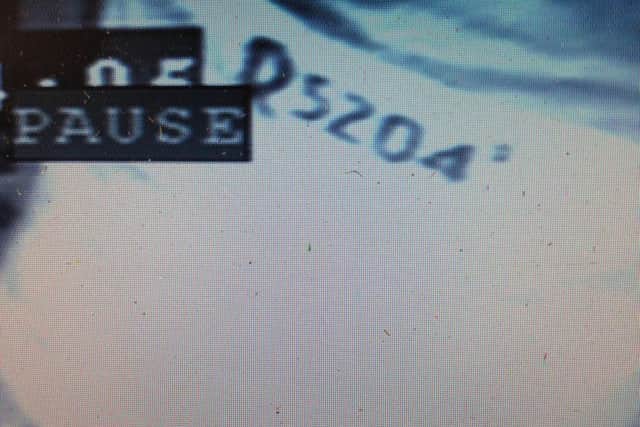 The distinct marking on the back of one of the raider's jackets.