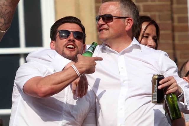 GLORY DAY - Dave Buchanan and Chris Wilder enjoy the open top bus celebrations following the Cobblers' title success last May
