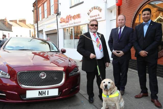 Councillor Malpas with his guide dog Verity, Northampton South MP David Mackintosh and Saffron owner Naz Islam.