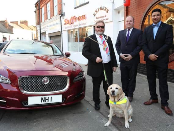 Councillor Malpas with his guide dog Verity, Northampton South MP David Mackintosh and Saffron owner Naz Islam.