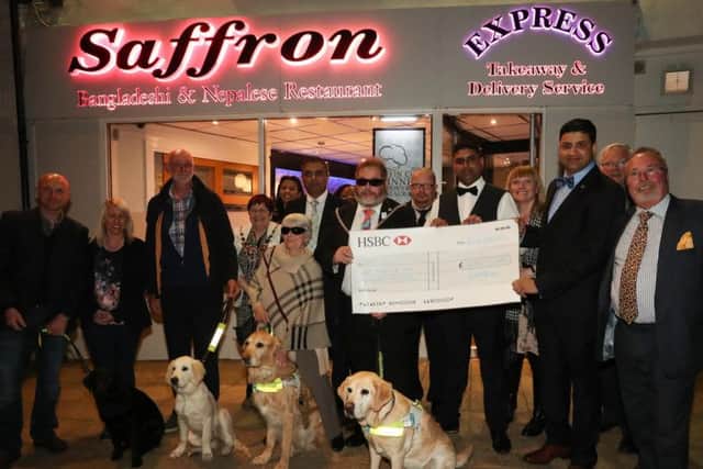 The cheque presentation outside Saffron