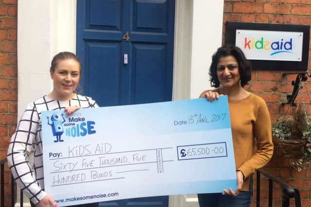 KidsAid's office manager Becca Caswell-Fox and charity manager Suki Bassi with the surprise cheque.