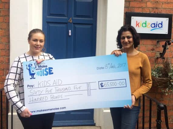 KidsAid's office manager Becca Caswell-Fox and charity manager Suki Bassi with the surprise cheque.