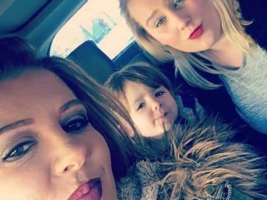 Charley, far right, with her mum Hayley and young sister.