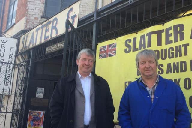 Max and John Slatter outside their father's shop. "Half the sign is missing. Storm Doris blew the 'sons' off."
