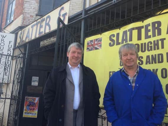 Max and John Slatter outside their father's shop. "Half the sign is missing. Storm Doris blew the 'sons' off."